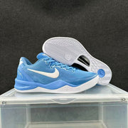 Blue and white low-top basketball shoe with outsole visible