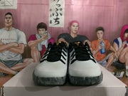 Front view of the GiGi sneakers showing white toe panels, black laces, black collars, and gray translucent-looking outsole sections.