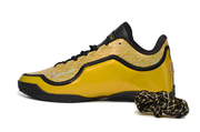 Side profile of a yellow and black Nike LeBron 23 basketball shoe with a patterned upper.
