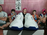 Front view of white basketball shoes with deep blue outsole sections