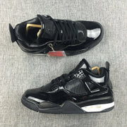Pair of black Air Jordan 4 high-top sneakers shown from above and the side on a gray fabric surface.