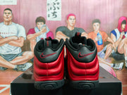 Rear view of black and red high-top sneakers showing black heel panels, red stitching, and a black outsole.