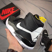 Rear three-quarter view showing Jordan heel branding, white heel panel, elephant-print side panel, and layered sole.