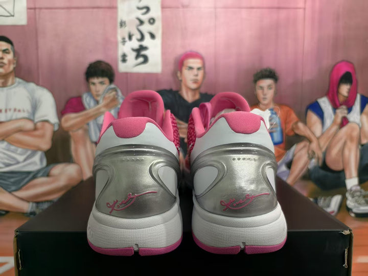 Rear view of pink and white Nike KD sneakers showing silver-gray heel panels and pink outsole accents.