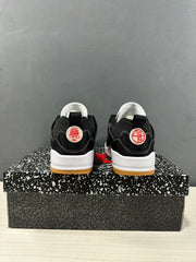 Rear view showing the black heels, white midsoles, circular heel details, and gum-colored outsoles.