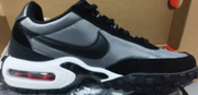 Side view of a black and grey sneaker with a white midsole.