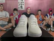 Front view of white Nike basketball sneakers showing the laces, textured uppers, tongue emblems, and layered white outsoles.