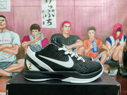 Side profile of a black and white Kobe Gigi basketball shoe with a white Swoosh.