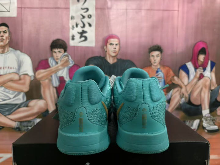 Rear view of lake blue Nike sneakers showing padded collars, tonal stitching, and matching midsoles.