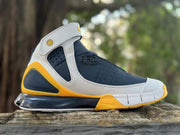 Side profile showing the ankle strap and perforated panels on the Nike Kobe 2K5