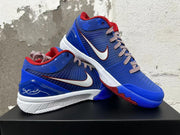 Pair of blue and red Nike Kobe basketball shoes shown at an angle, highlighting the Swoosh and red outsole accents.