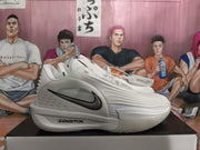 Side profile of the white Nike sneaker showing layered textured panels, black Swoosh branding and the ZoomX marking.
