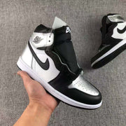 Front three-quarter view of the black, white, and metallic silver high-top sneaker.