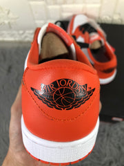 Close-up of the orange heel with a black Air Jordan Wings-style logo.