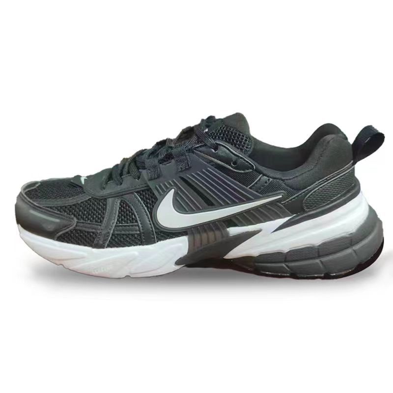 Side view of black mesh Nike sneakers with a white Swoosh and contrasting sculpted sole