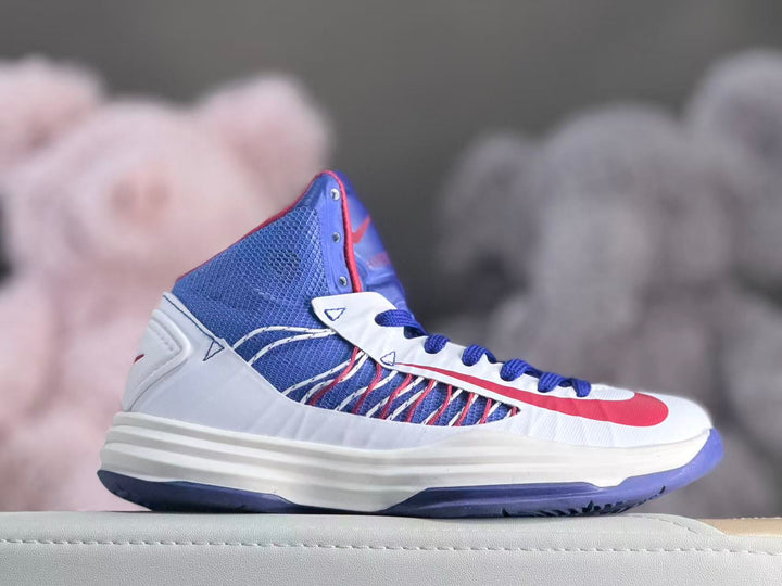 Side view of a white, blue, and red Nike HD2012 kids' high-top shoe