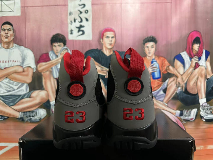 Rear view of black and grey Jordan high-top sneakers with red heel details