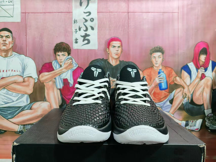 Front view of black and white Kobe Gigi basketball shoes with white laces and textured uppers.