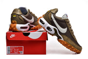 Nike Air Max Waffle SP sneakers in brown and olive with white Swooshes and orange-brown lugged soles, shown with a Nike shoe box
