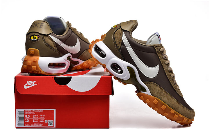 Nike Air Max Waffle SP sneakers in brown and olive with white Swooshes and orange-brown lugged soles, shown with a Nike shoe box