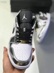 Top view showing the black tongue, black laces, perforated white toe box and gold-tone lace accessory.