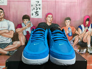 Front view of blue Nike basketball sneakers with blue laces, black collars, and small Swoosh logos.