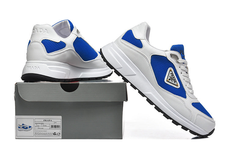 White and blue low-top sneakers displayed with a shoe box.