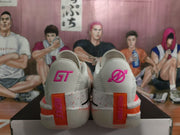 Rear view showing GT heel branding, orange heel accents, and speckled midsole sections.