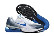 Pair of white and blue Nike Air Max sneakers shown from the side and underside.