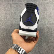 Rear view of the sneaker showing the black heel tab, blue logo detail, and layered white and black heel construction.