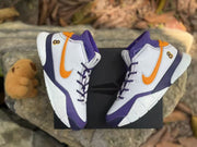 Overhead view of the pair highlighting the orange side accents, purple laces and number 8 details.