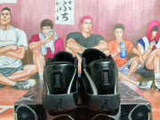 Rear view of a pair of black and grey Jordan sneakers