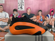Side view highlighting the orange outer panel, black inset ventilation detail, and black upper.