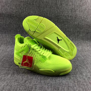 Fluorescent green sneakers shown with one outsole facing upward, revealing the patterned tread and black Jordan logo insert.