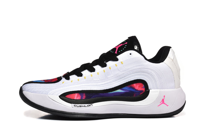 Side profile of a white and black Jordan basketball sneaker with multicolor side detailing and pink logo accents.