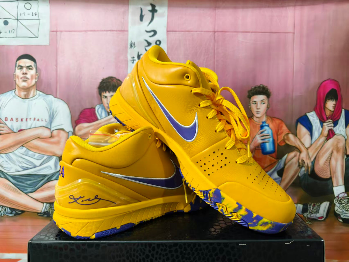Pair of yellow-gold and purple high-top basketball sneakers shown from a three-quarter side view.