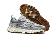 Pair of grey Louis Vuitton sneakers showing side profile and gum-colored outsole