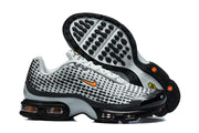 Pair of grey and black Nike Air Max Plus VII sneakers, showing the patterned upper and outsole.
