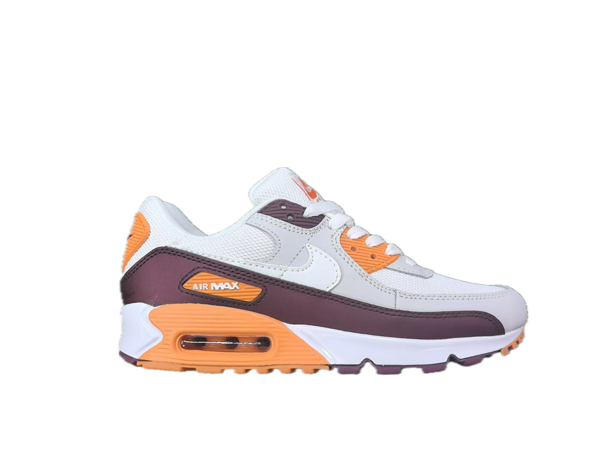Side view of a white Nike Air Max 90-style sneaker with orange and plum-colored accents and a visible cushioning window.