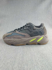 Side profile highlighting the gray upper, blue panels, lime midsole accents, and textured outsole.
