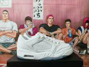 Side profile of a white sneaker showing its perforated panel, layered midsole, molded detailing, and translucent outsole.