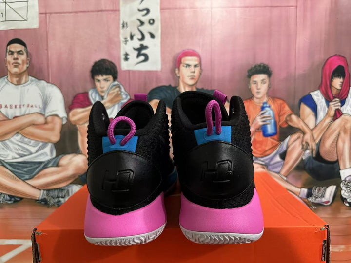 Rear view of black Nike basketball shoes with pink heel panels and blue accents