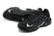 Black Nike sneakers shown from above, highlighting the laces, toe panels and cage design.