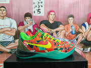 Side view highlighting the red, green, and teal graphic shoe with bright yellow laces and a contrasting colorful partner shoe.
