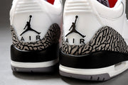 Close-up rear view showing the Jumpman heel logos, elephant-print panels, black heel sections, and gray outsoles.
