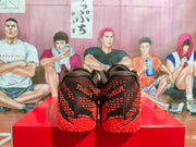 Rear view showing red embroidered branding and textured black-and-red uppers.