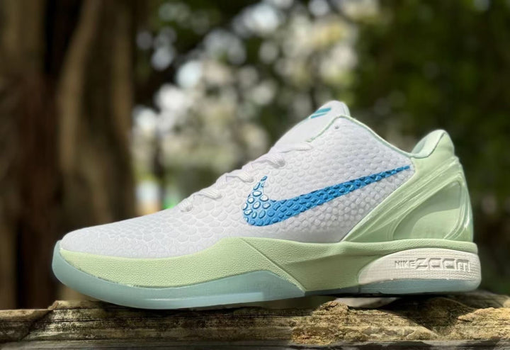 Side view of white Nike Kobe 6 shoes with blue Swoosh and pale green panels