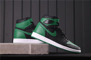 Side view of the pair displayed on a concrete ledge, showing the high-top profile and green outsole.
