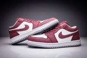 Pair of low-top Jordan sneakers in white and burgundy shown from an angled side view.