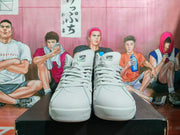 Front view of gray high-top sneakers with matching laces, padded tongues, and blue accents visible at the collar.